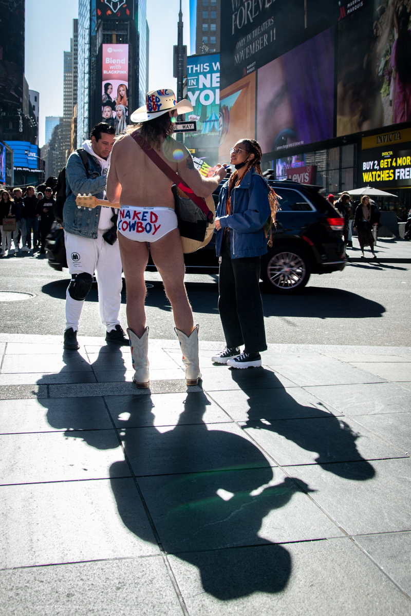 The Naked Cowboy sings to tourists at a balmy 56 °F.